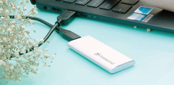 USB SSD Drive In White Plugged In Notebook