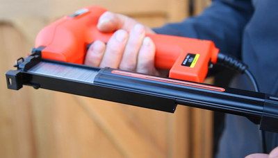 Electric Powered Hand Staple Gun In Man's Hand