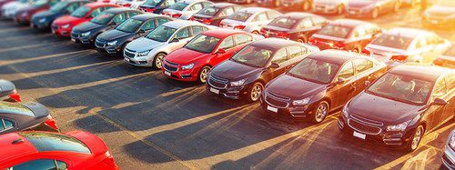 Red Cars Lined Up Vehicles In Strong Sunlight