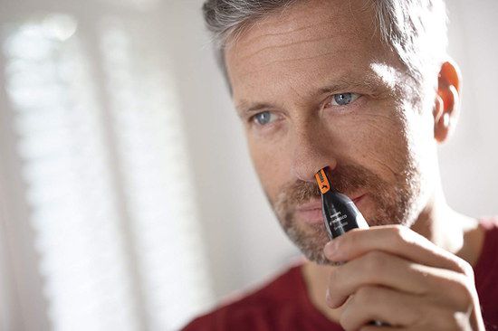 Electric Nose Hair Trimmer In Mans Hand