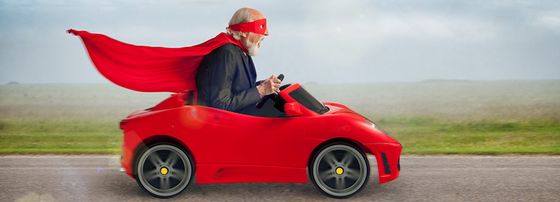 Cute Caped Man In Little Red Car