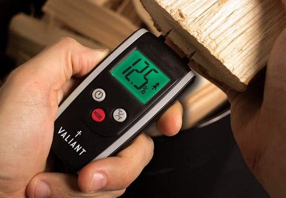 Damp Test Meter In Black On Big Log