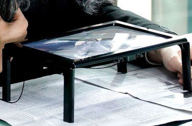LED Magnifying Glass On Stand Magnifying Glass On Stand Above Newspaper